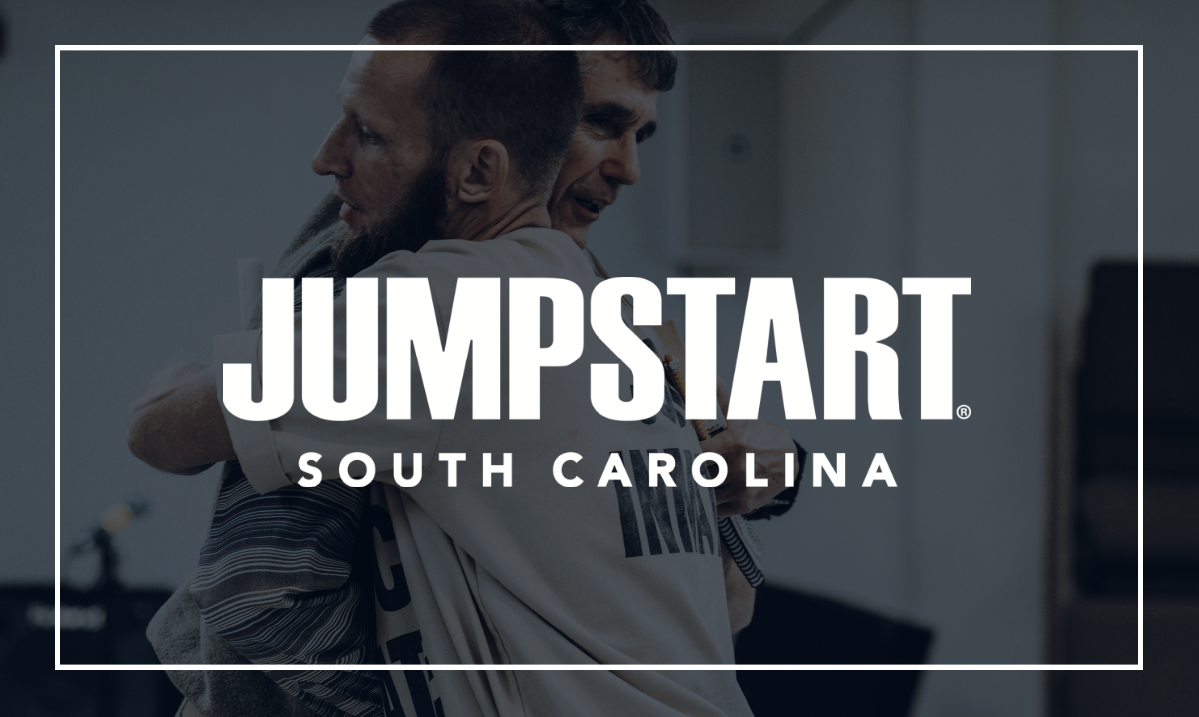 Jumpstart South Carolina — two men embracing inside a correctional facility, representing transformation and brotherhood through prison ministry